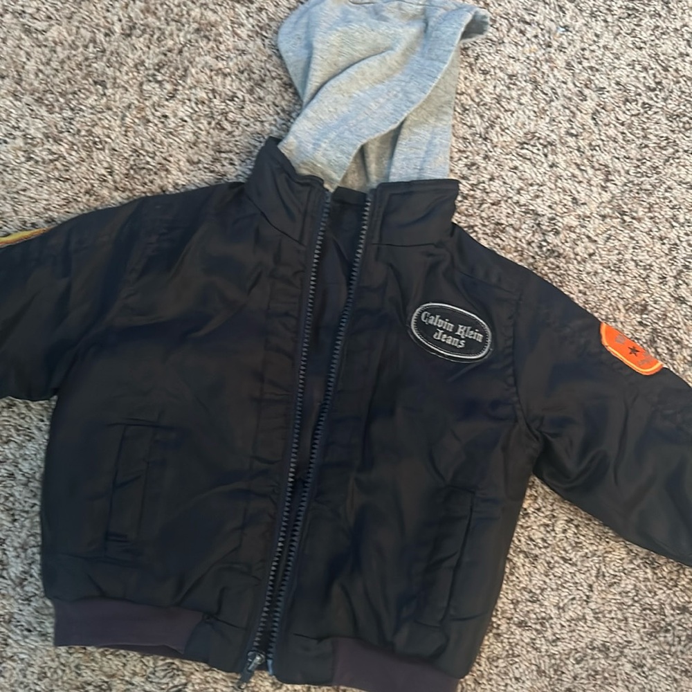 Calvin Klein. 24 mo black jacket.100%poly. Gray hood. Zipper front with grayhood